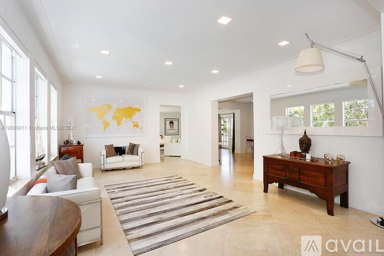 A living room with a world map on the wall and a striped rug on the floor.