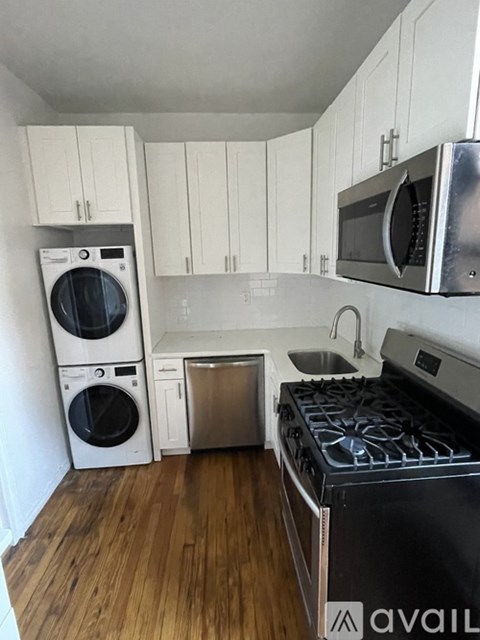 A kitchen with a stove top oven, microwave, and a dishwasher.