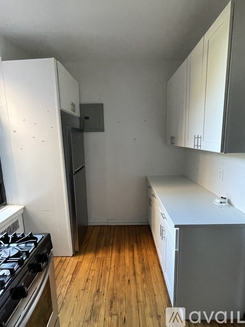 A kitchen with a stove top oven and a refrigerator.