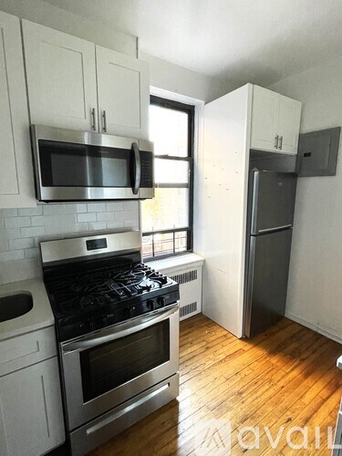 A kitchen with a stove, oven, and microwave.