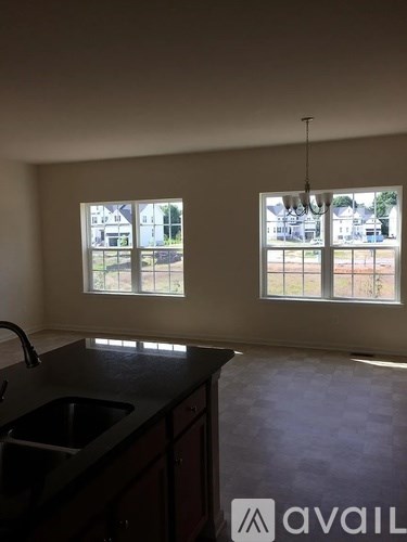 A kitchen with a sink and a window overlooking a street.