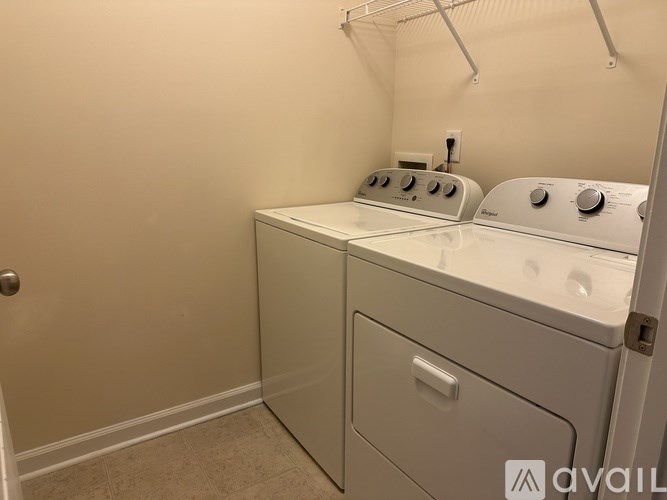 A small laundry room with a washer and dryer.