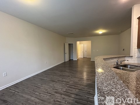 A kitchen with a sink and a counter top.