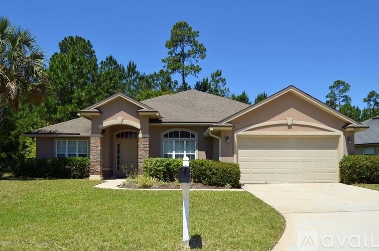 A house with a brown roof and a garage door is for sale.