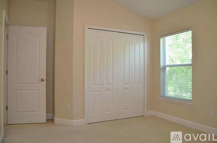 A room with two doors and a window.