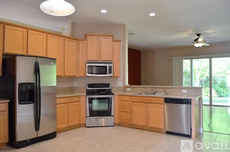 A kitchen with wooden cabinets and stainless steel appliances.
