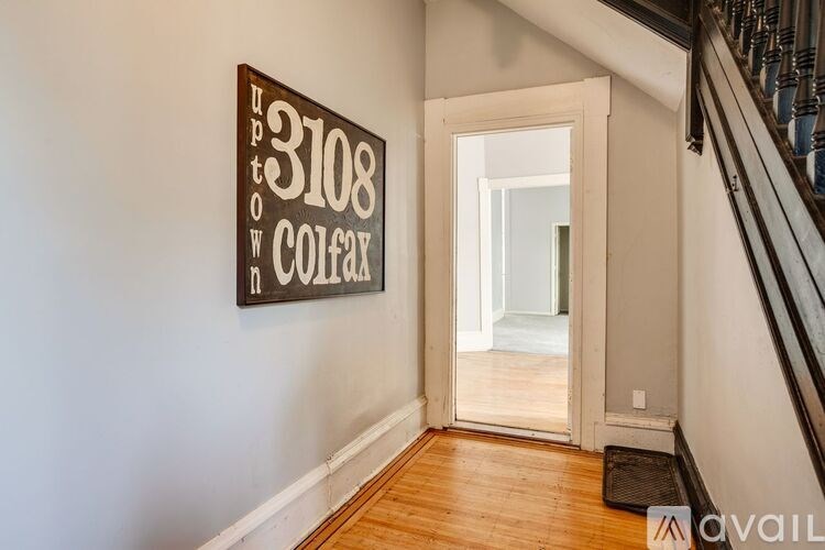 A sign on the wall that says "3108 Town Colfax Ave".