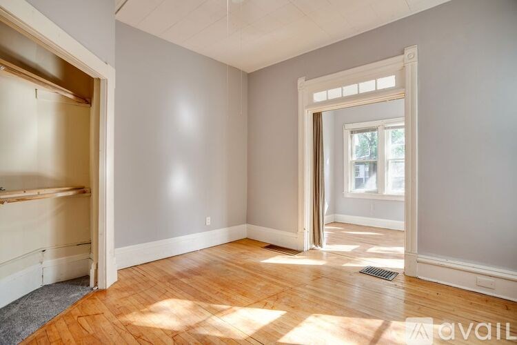 A room with wooden floors and a window.