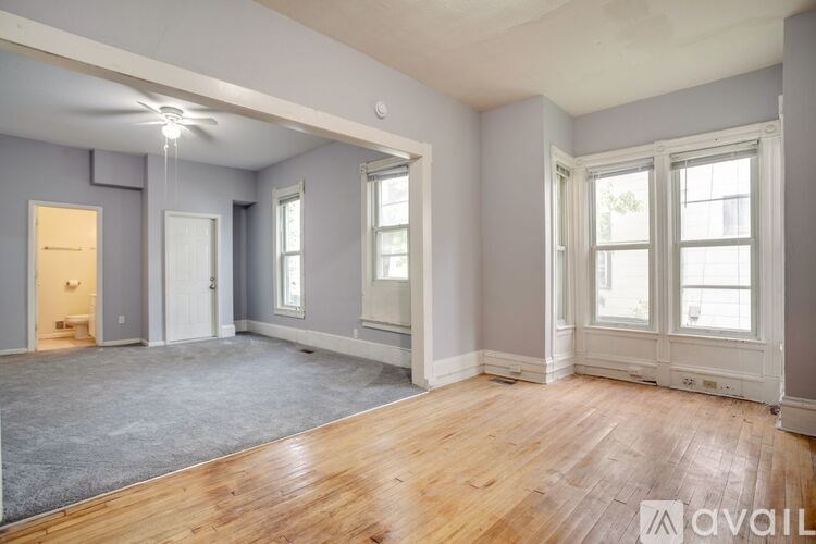 A room with wooden floors and grey walls.