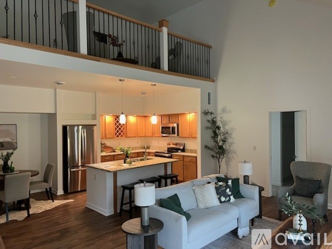A modern kitchen with a dining area and a living room.