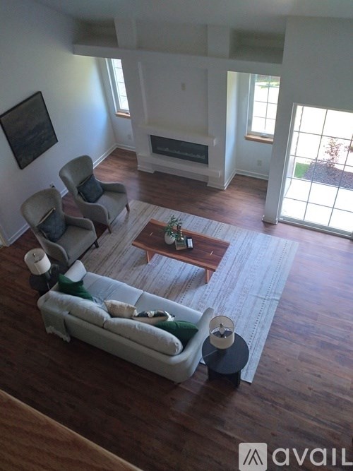A living room with a couch, chairs, and a coffee table.