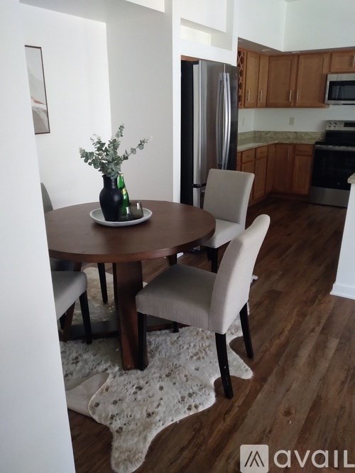 A kitchen with a table and chairs in the foreground.