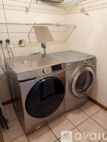 A washing machine and dryer are in a small room.