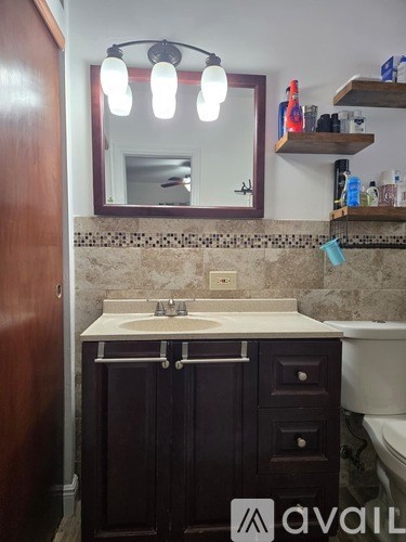 A bathroom with a sink, mirror, and medicine cabinet.