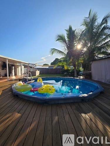 A pool with a blue tarp and a yellow inflatable duck.
