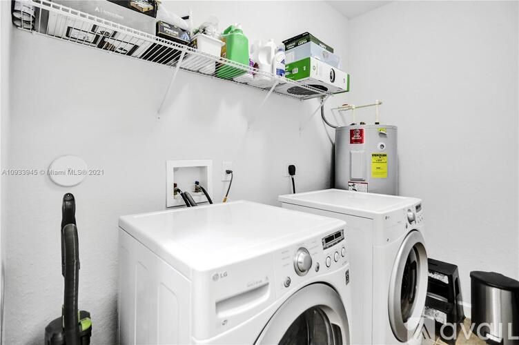 A white washing machine and dryer in a small laundry room.