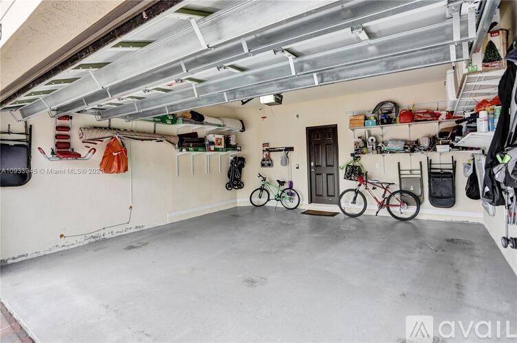 A garage with a bicycle and a skateboard.