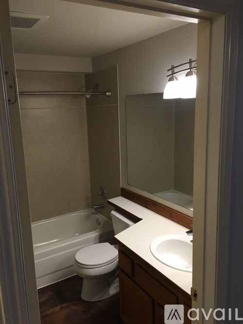 A bathroom with a toilet, sink, and bathtub.