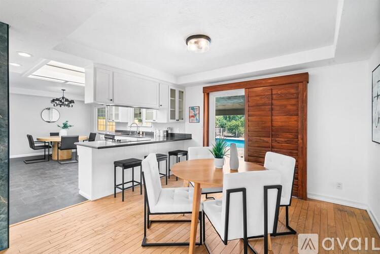A modern kitchen with a dining table and chairs.