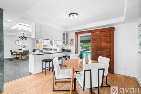A modern kitchen with a dining table and chairs.