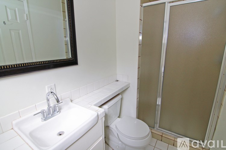 A bathroom with a sink, toilet and shower.