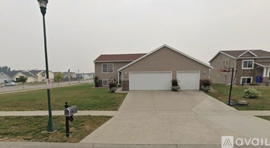 A house with a garage and a driveway in front of it.