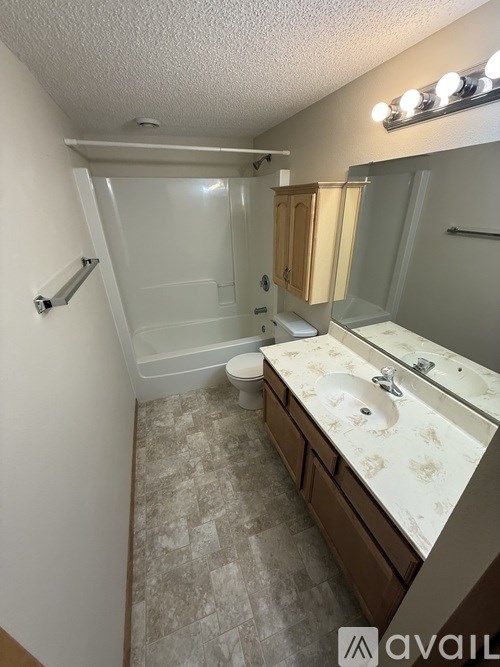 A bathroom with a sink, mirror, and toilet.