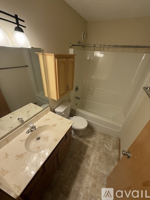 A bathroom with a sink, toilet, and bathtub.