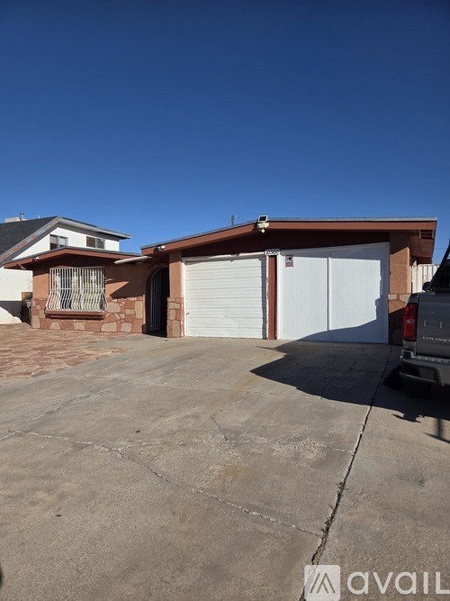 A house with a garage and a driveway in front.