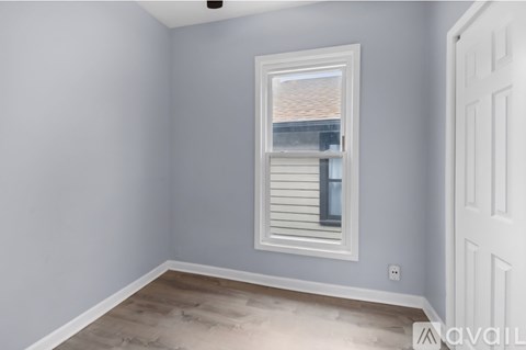 A room with a window and a door.