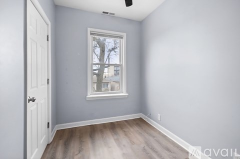 A room with a window and a door.