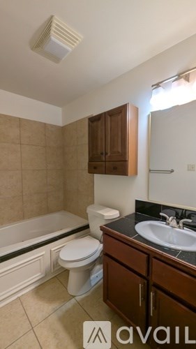 A bathroom with a toilet, sink, and bathtub.