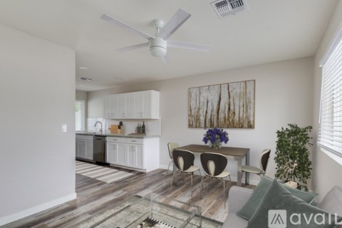 A living room with a dining table and chairs.