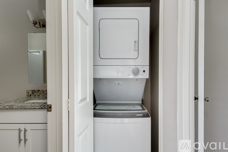 A white dishwasher is open and appears to be empty.