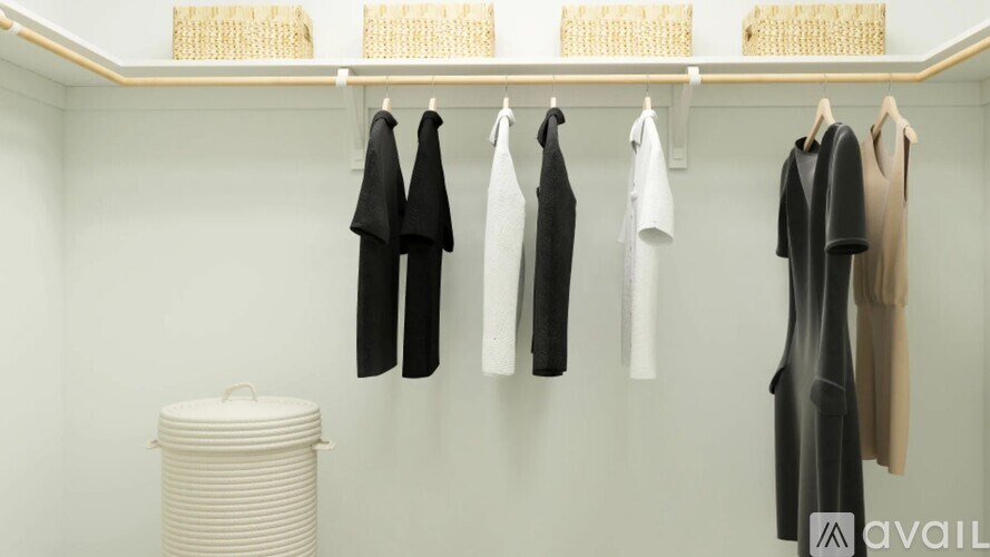 Clothes hanging on a rack in a room.