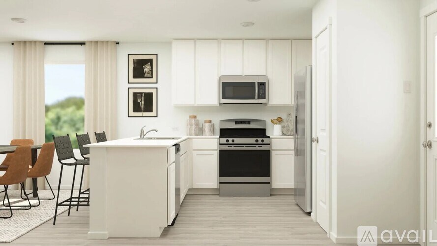 A modern kitchen with white cabinets and a black stove top oven.