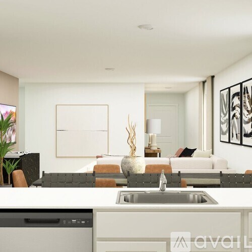A modern kitchen with a white countertop and a black dishwasher.