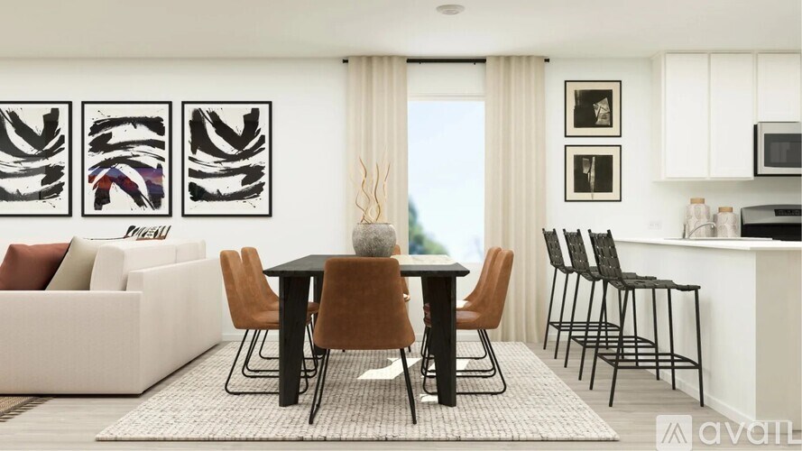 A modern dining room with a black table and chairs.