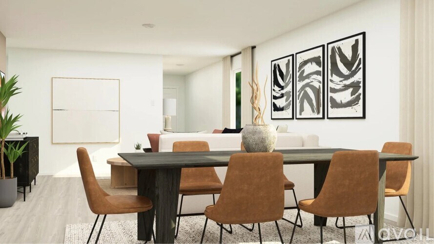 A modern dining room with a large table and chairs.
