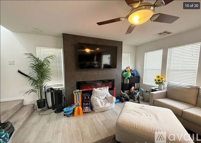 A living room with a fireplace, a television, and a couch.