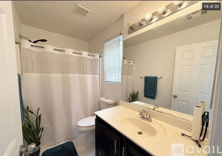 A bathroom with a white sink and a white toilet.