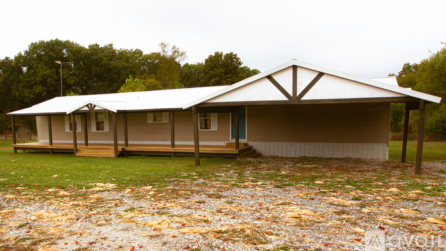 A house with a metal roof and a porch.