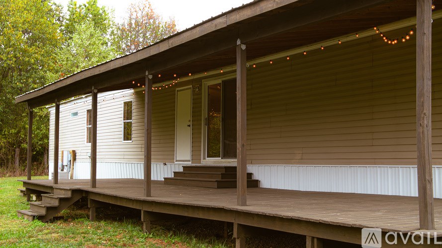 A house with a porch and lights strung up on the roof.