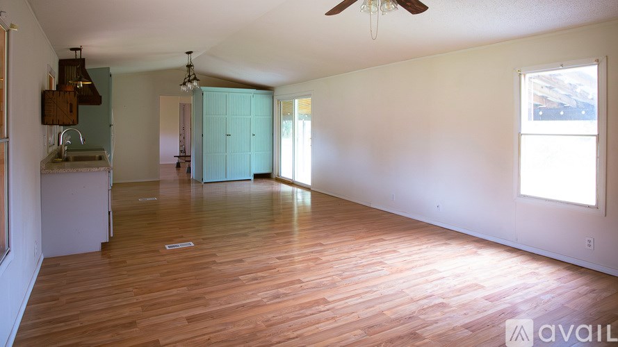 A room with wooden floors and a ceiling fan.