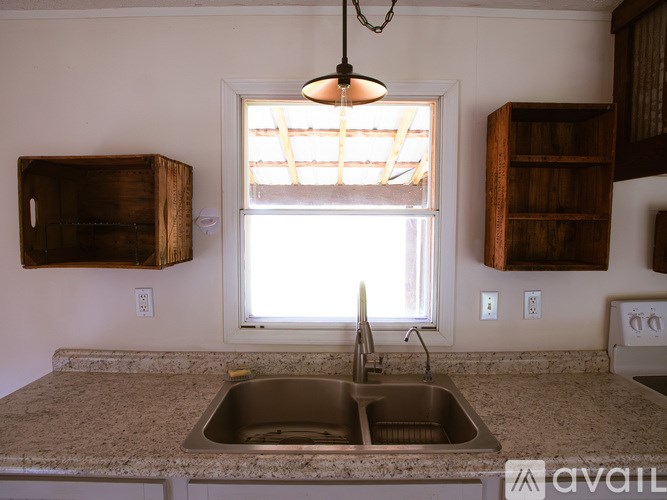 A kitchen with a sink and a window.