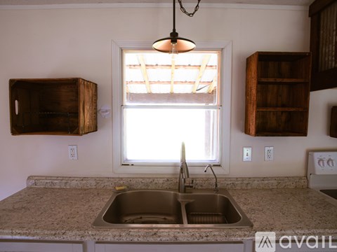 A kitchen with a sink and a window.