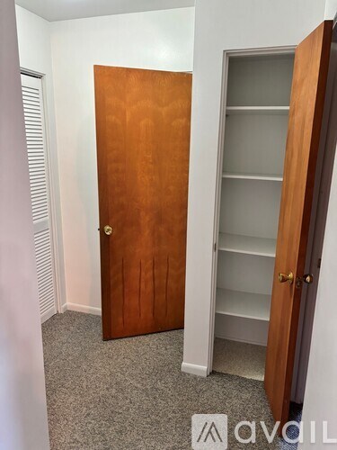 A wooden door with a glass panel is closed.