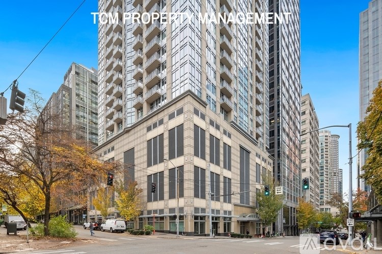 A modern building with the words "Tom Property Management" on the top.