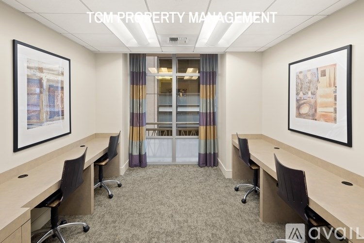 A room with a carpeted floor and a glass door in the background.