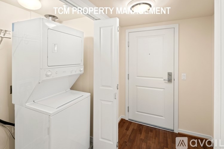 A white refrigerator is in a room with a door and a white door.